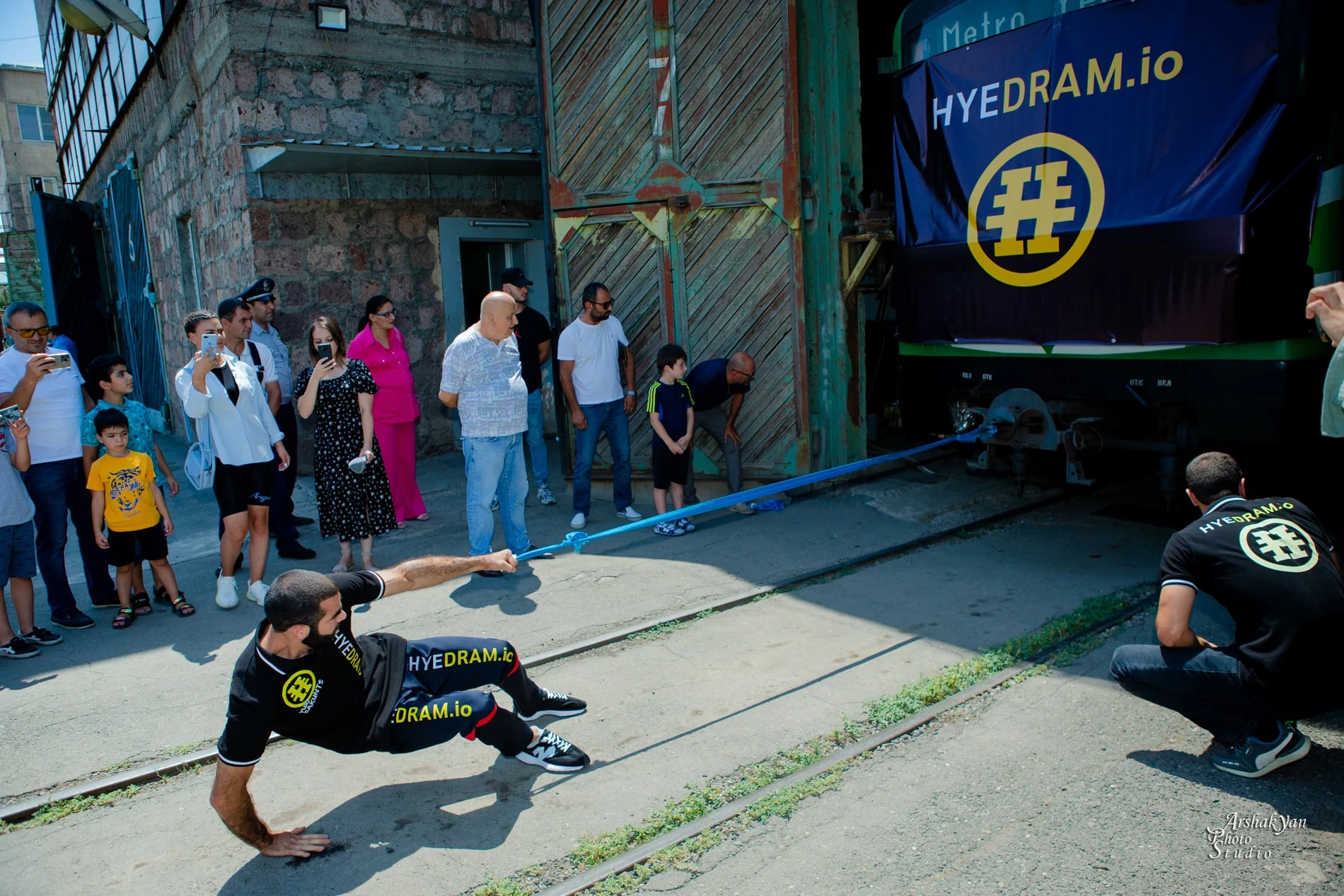Yuri Sakunts pulling the Metro Yerevan rail vehicle during a HYEDRAM strength performance